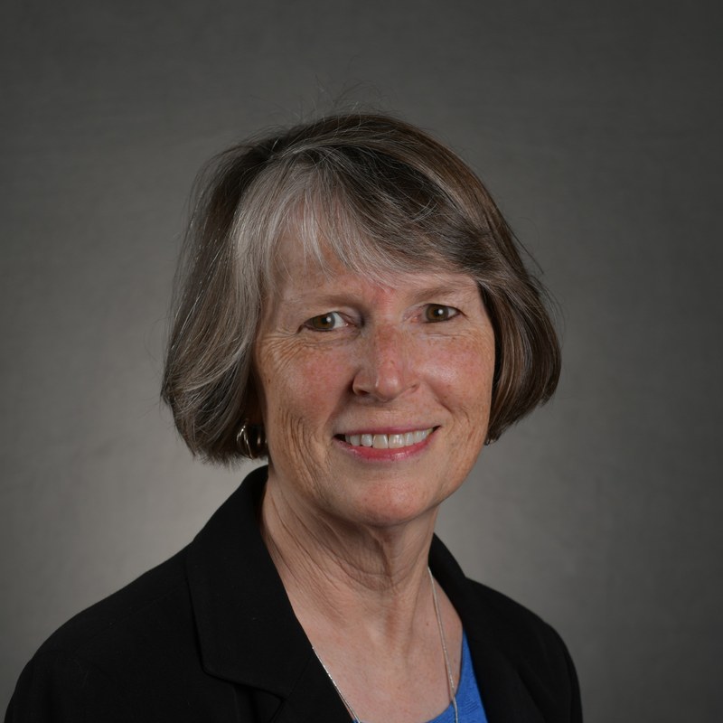 Dee Jones, original studio headshot on a gray background